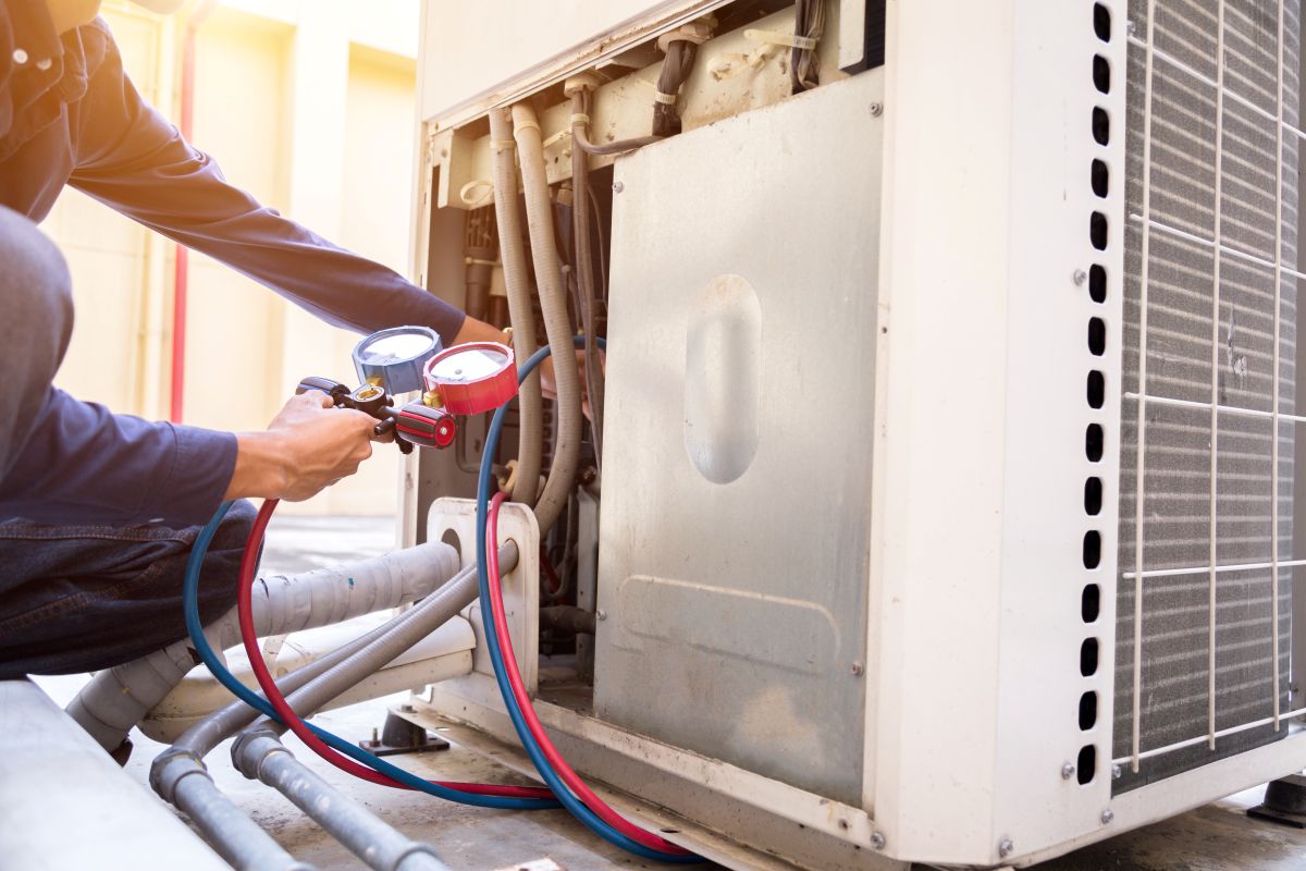Technician is checking air conditioner ,measuring equipment for filling air conditioners